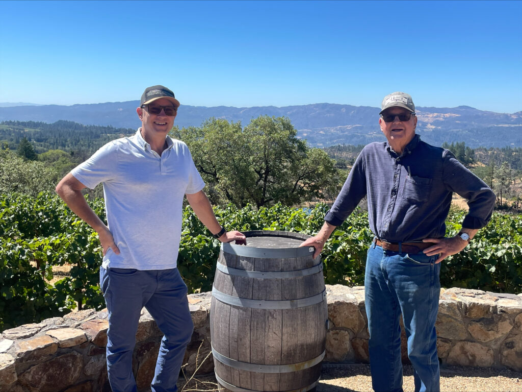 Elton Slone & Jim Bundschu with vineyard in background